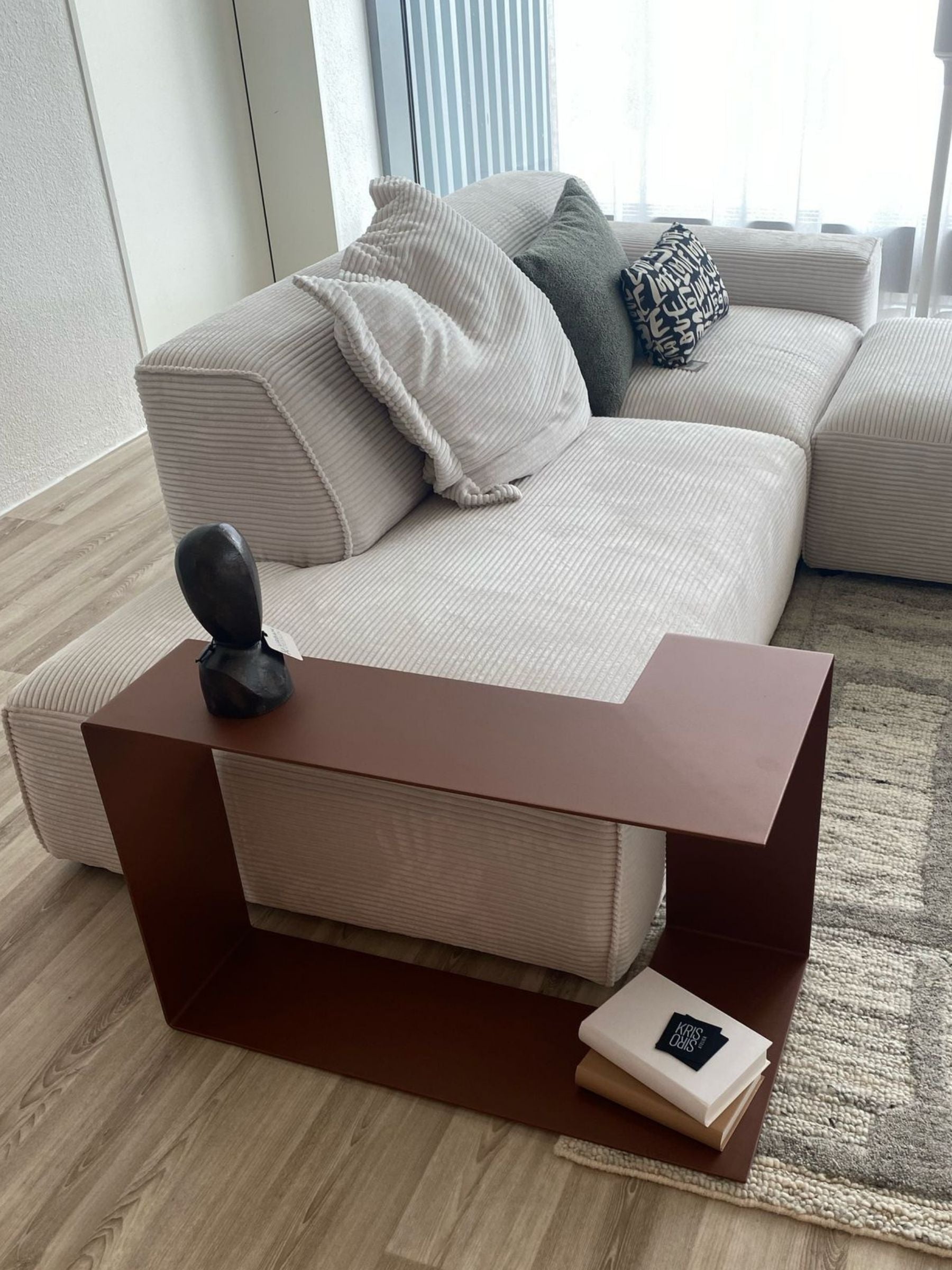 Sofa Beisteilltisch in Bronze neben einem cremefarbenen Sofa
